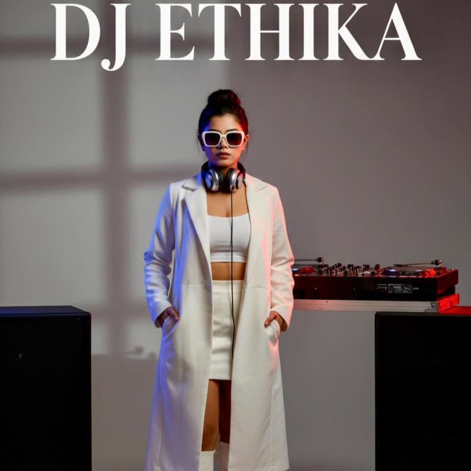 DJ Ethika portrait in white outfit with headphones