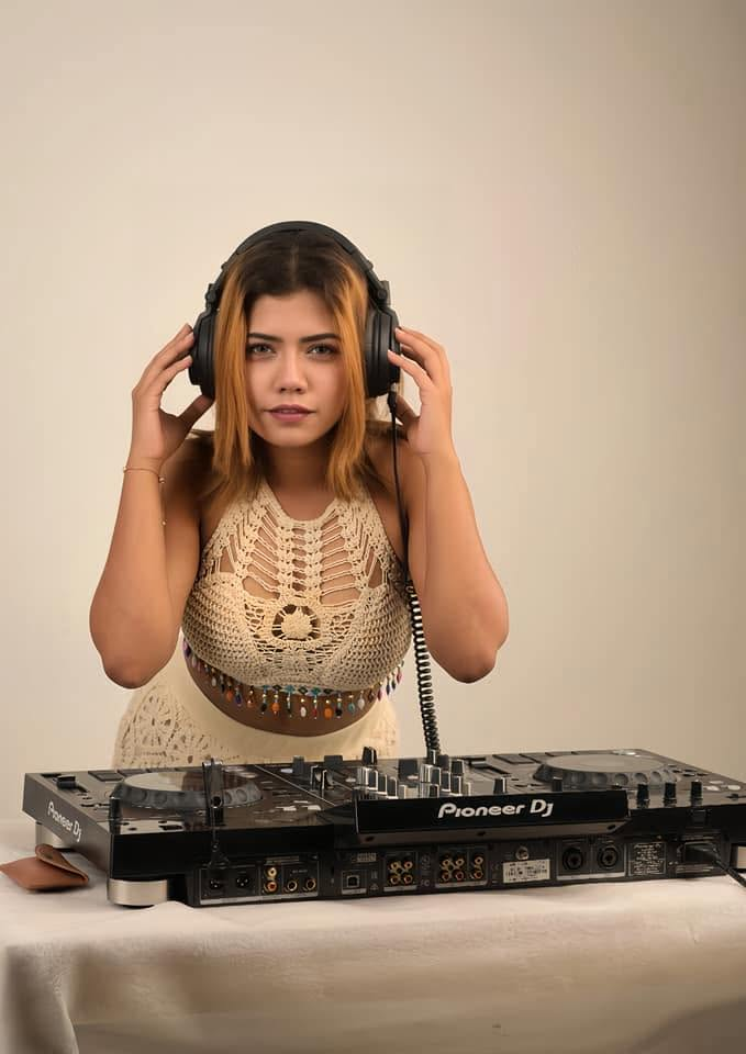 DJ Ethika wearing headphones at Pioneer DJ gear